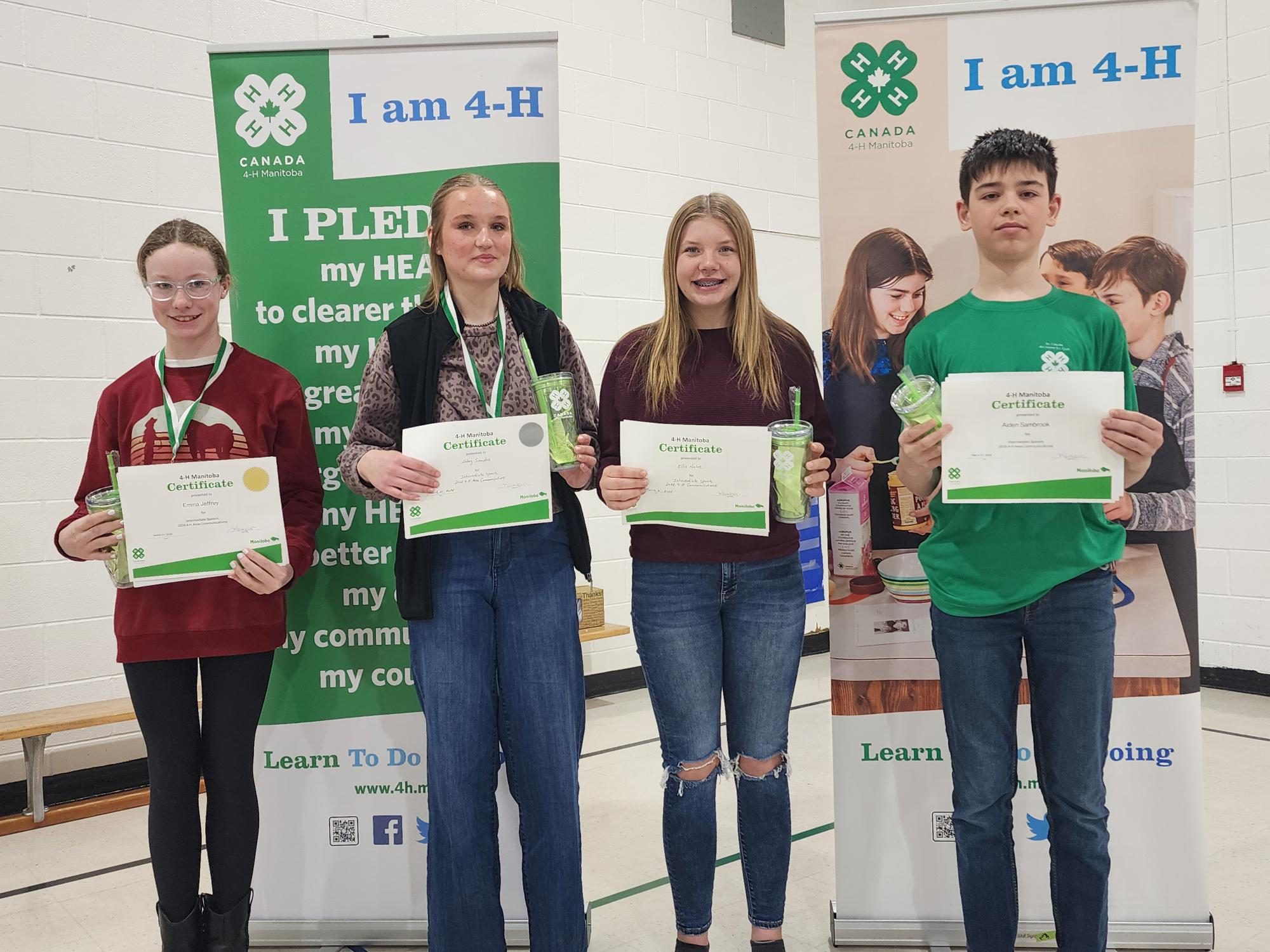Kids stand smiling with their certificates.