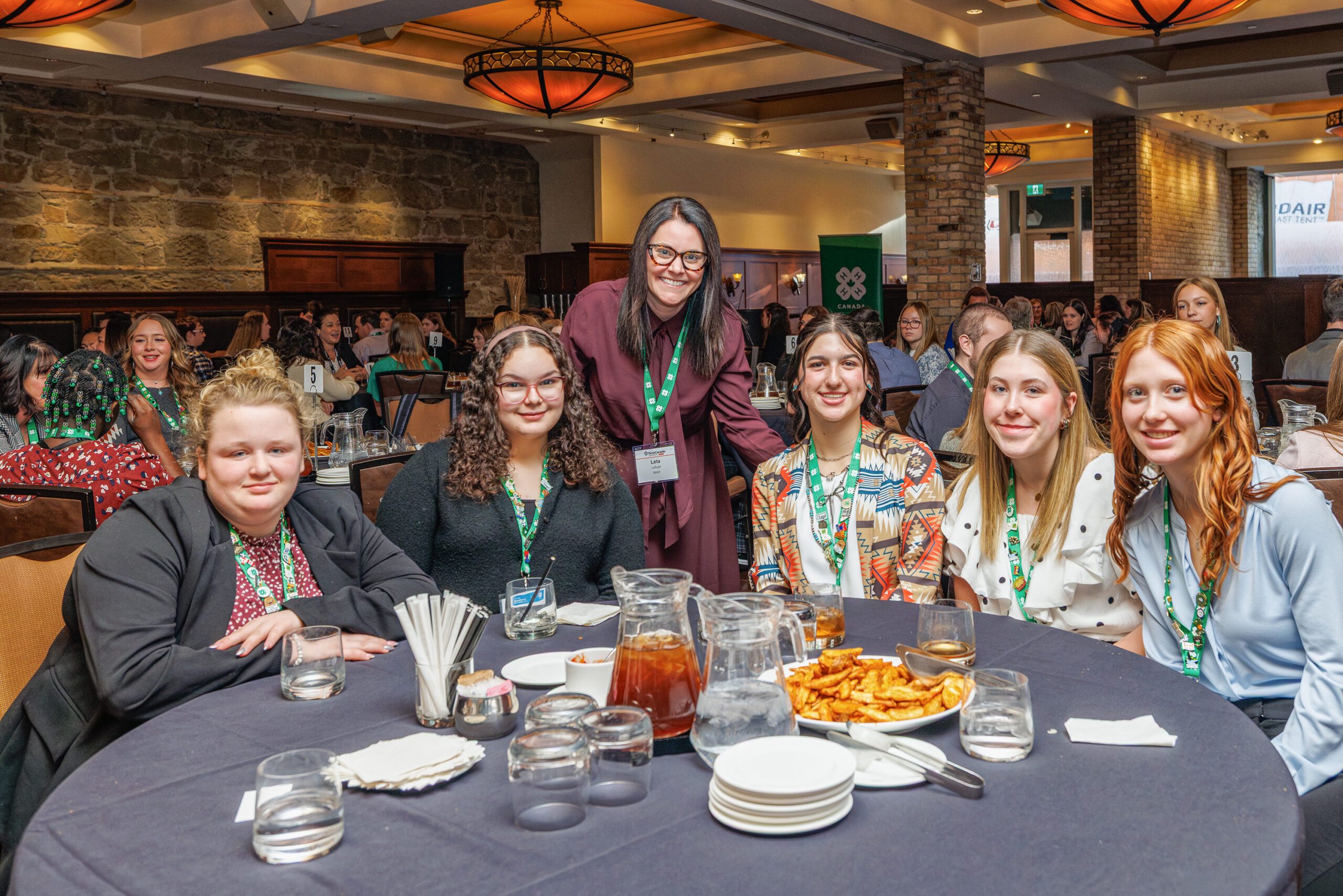 4-H members pose for a picture at a table